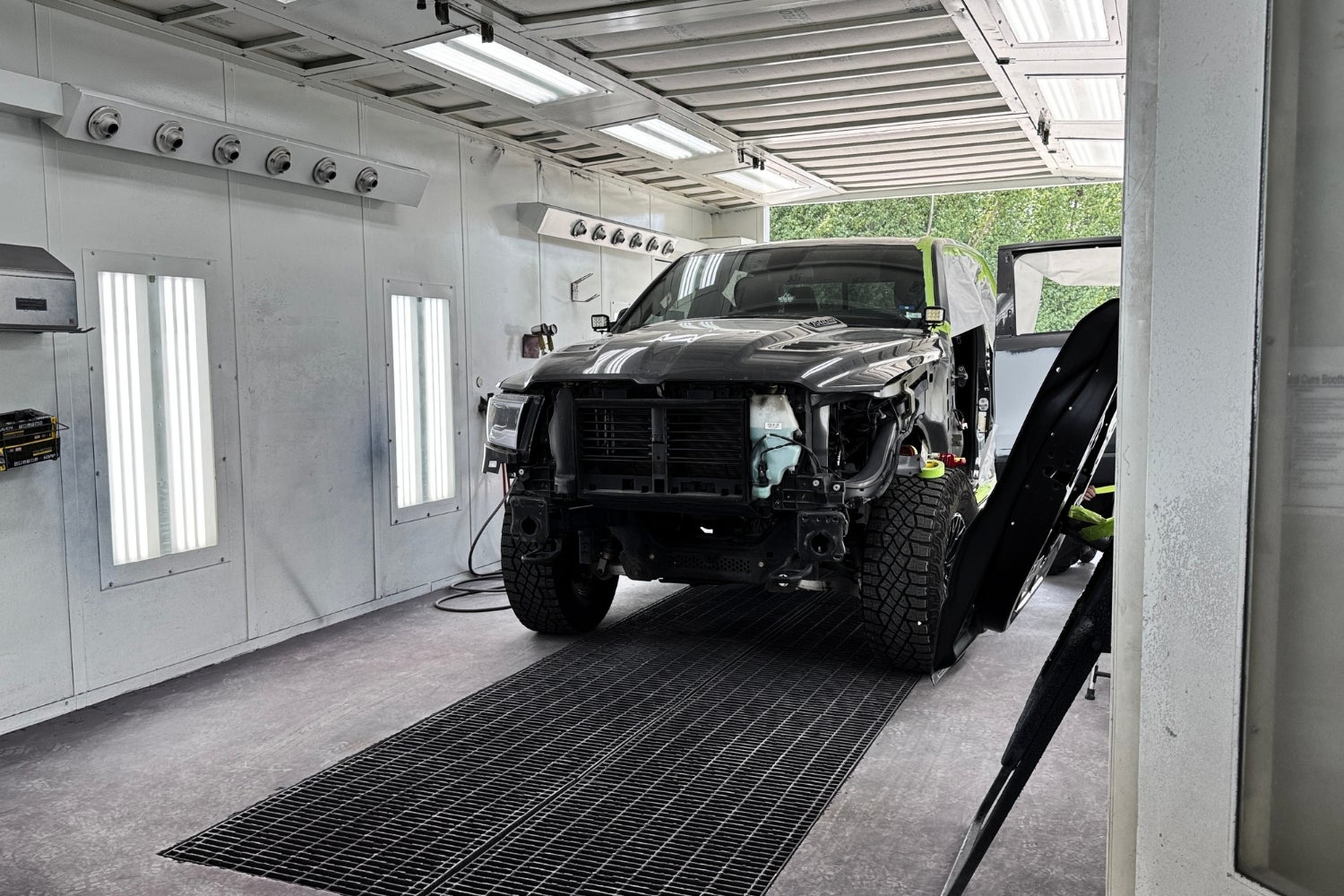 Truck being repaired inside a paint booth at Dave Sinclair Buick GMC Collision Center