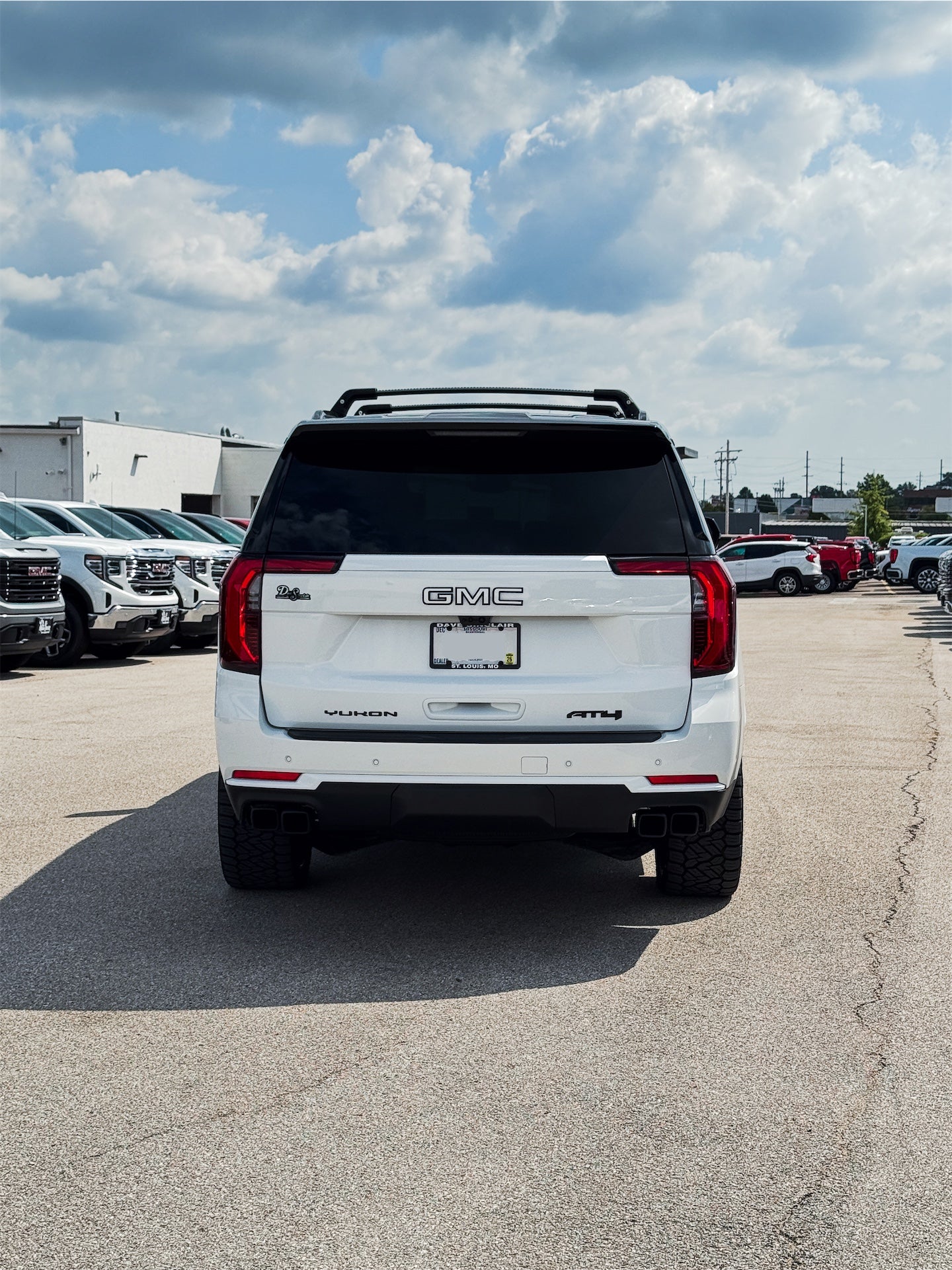 Rear view of custom 2026 GMC Yukon AT4 Ultimate showing chrome delete and two-tone exterior